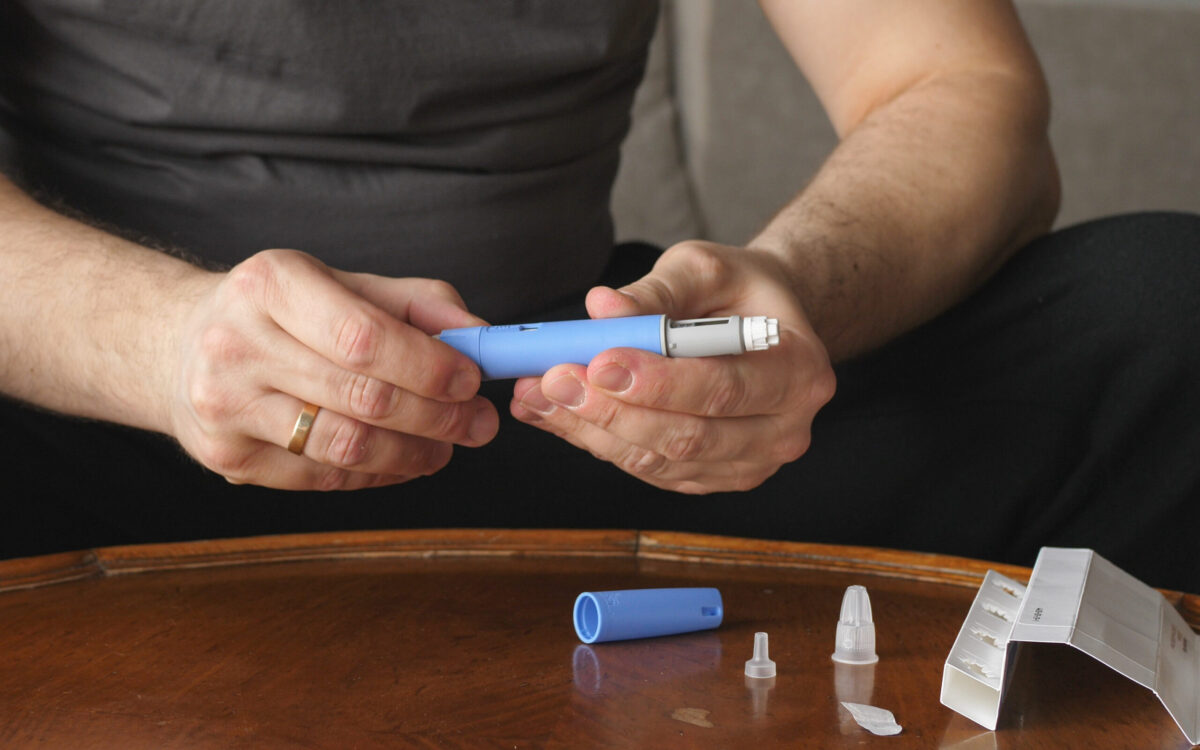 Obese fat man preparing Weight Loss Jab Ozempic