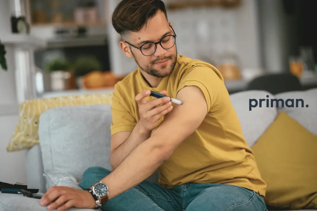 Young man giving himself a weight loss injection shot